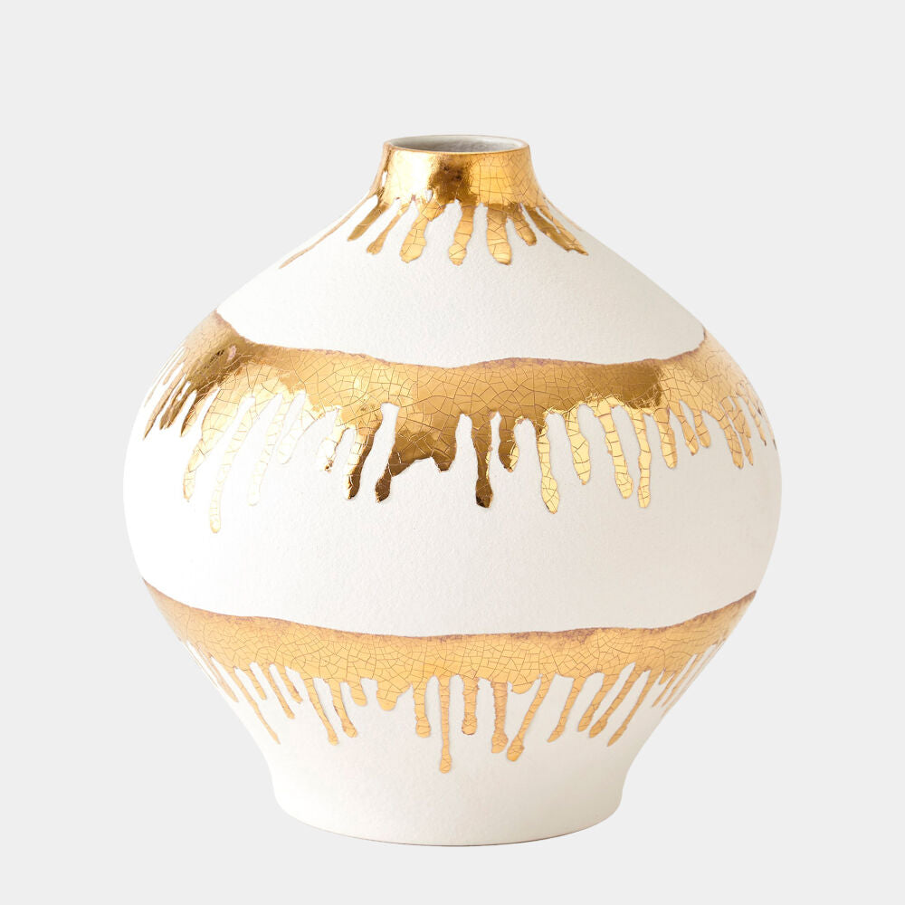 Decorative vase with gold driplike patterns on a white background