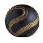 Black and gold ball with textured pattern on a white background