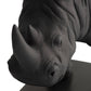 Close-up of a black rhinoceros head sculpture on a white background