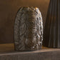 Decorative aluminum piece with textured surface on a wooden surface