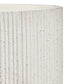 Close-up of a cylindrical planter or vase with a ribbed, vertically fluted texture in off-white with small speckled mineral-like inclusions, shown against a plain white background.