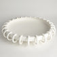 White ceiling light fixture with decorative design on a gray background