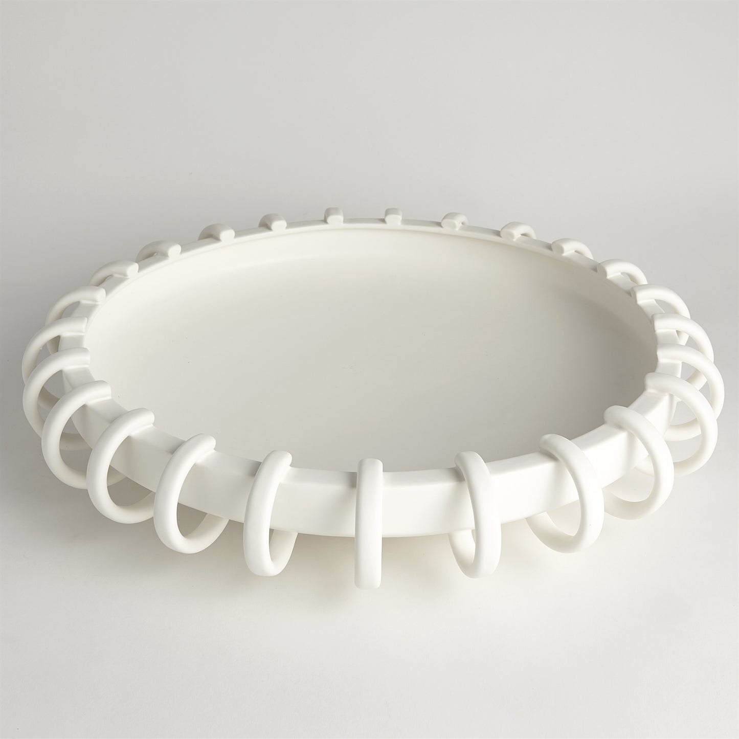 White ceiling light fixture with decorative design on a gray background
