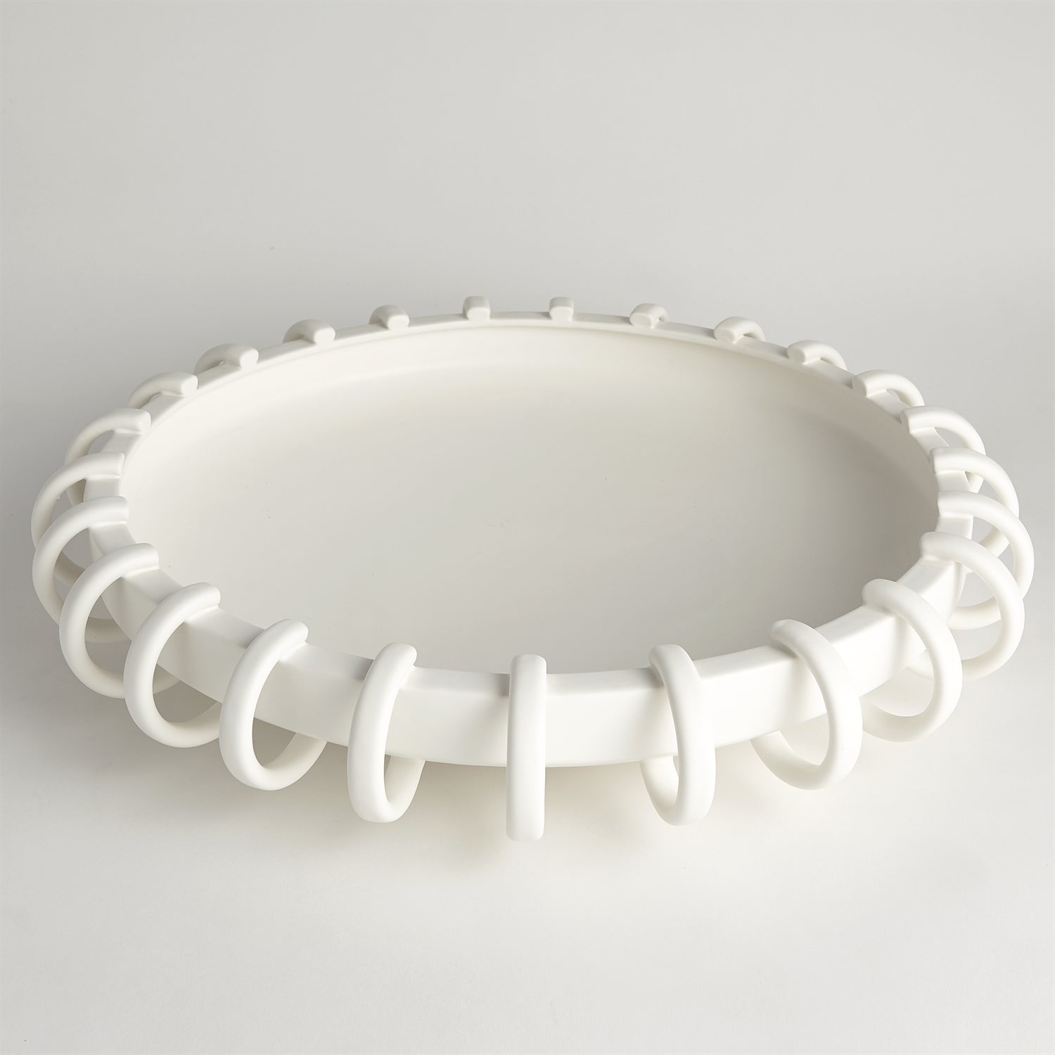 White ceiling light fixture with decorative design on a gray background