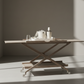 Wooden table with a minimalistic design in a room with sunlight casting shadows.