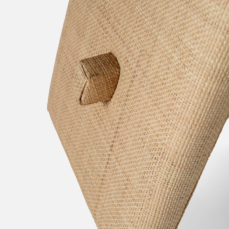 Close-up of beige fabric with a button on a white background