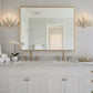 Bathroom vanity with large mirror, lights, and decor.