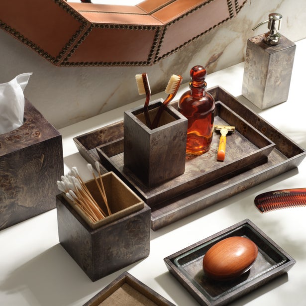 Bathroom accessories including a soap dish, toothbrush holder, and soap on a marble surface.
