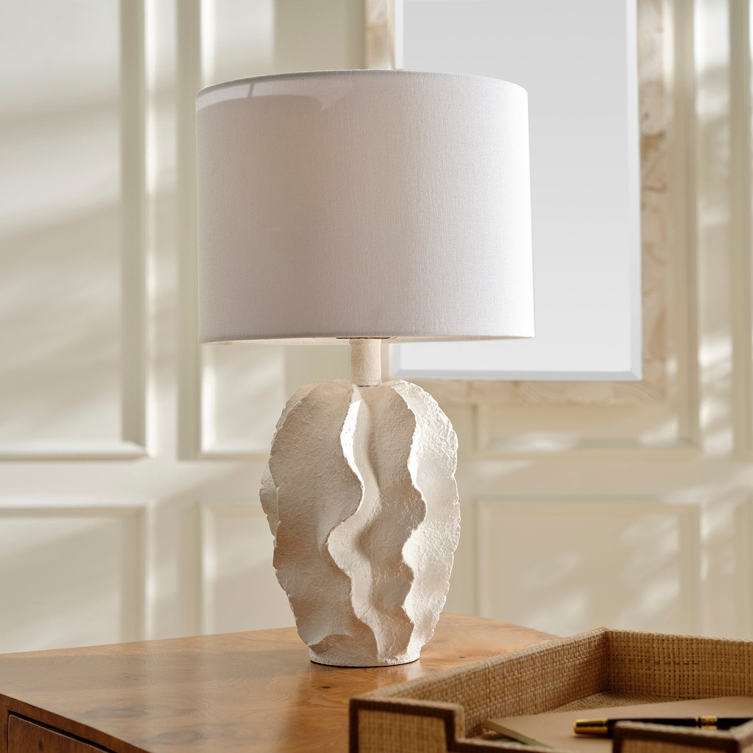 Table lamp with a textured base on a wooden surface
