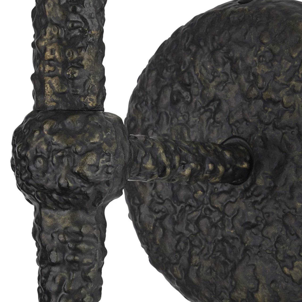 Close-up of a textured metal object with intricate patterns on a white background