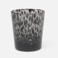 Glass tumbler with black and gray marbled pattern on a white background