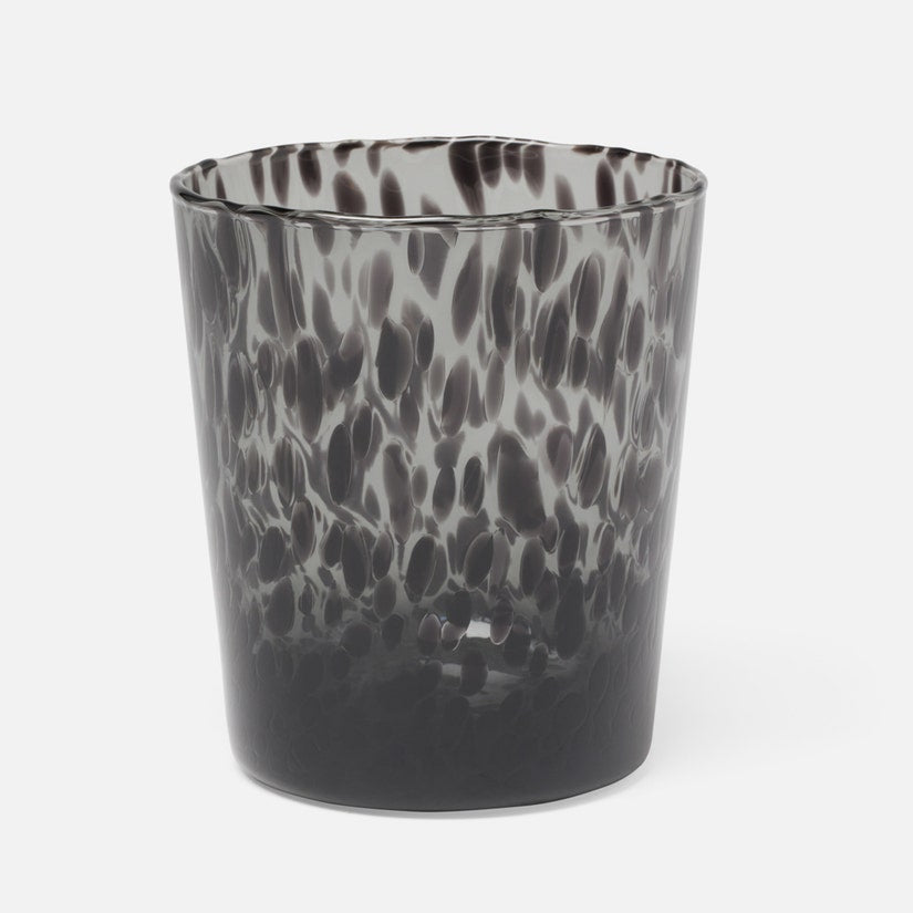 Glass tumbler with black and gray marbled pattern on a white background