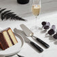Two cake knives with black handles on a tablescape