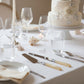 Two cake knives with ivory pearl-like handles on a white background