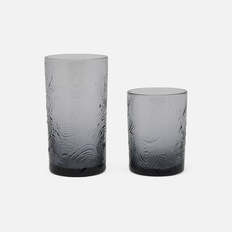 Two gray textured glass tumblers on a white background