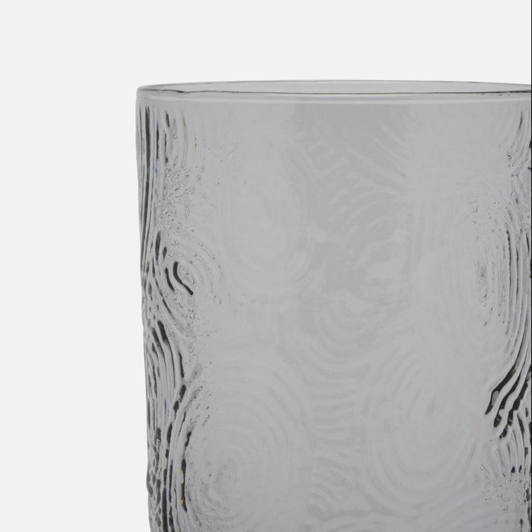 Clear glass with textured design on a white background