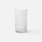 Clear glass vase with textured pattern on a white background