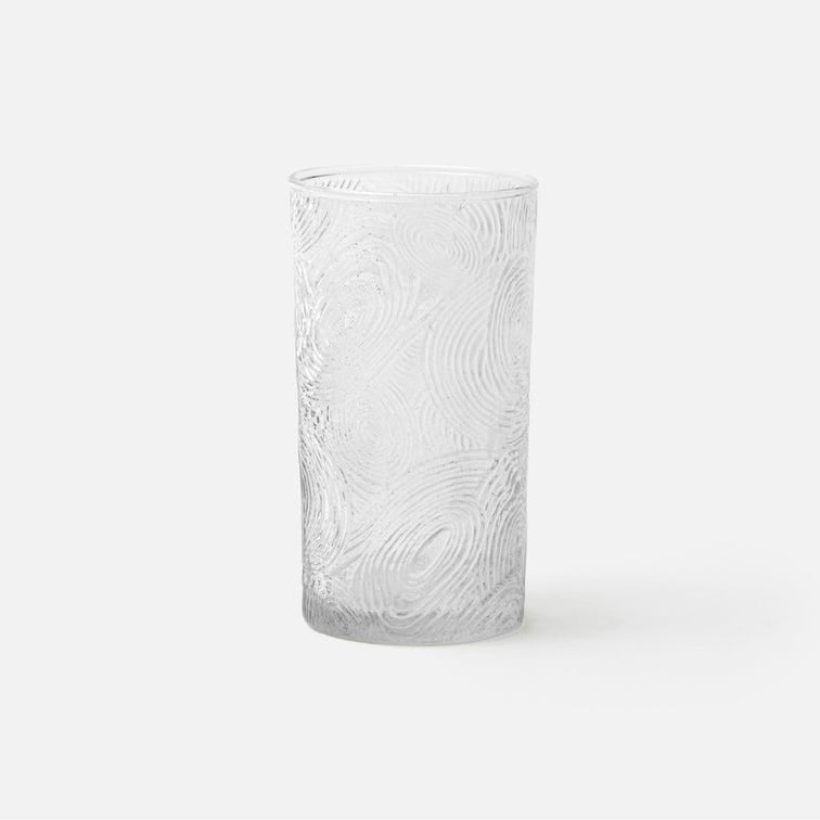 Clear glass vase with textured pattern on a white background