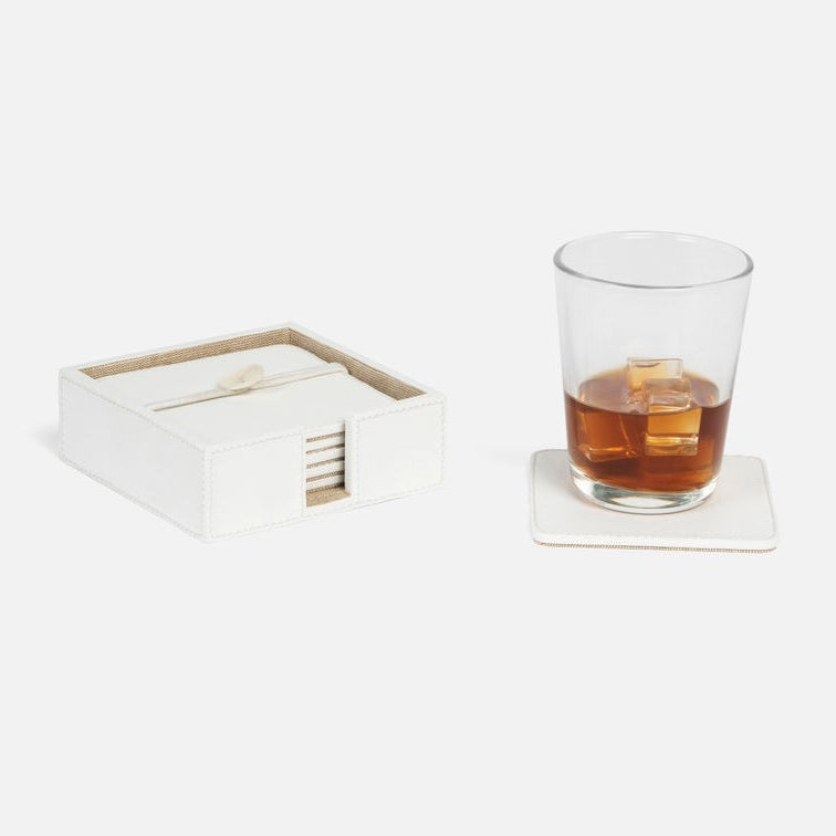 a square coaster set in white leather