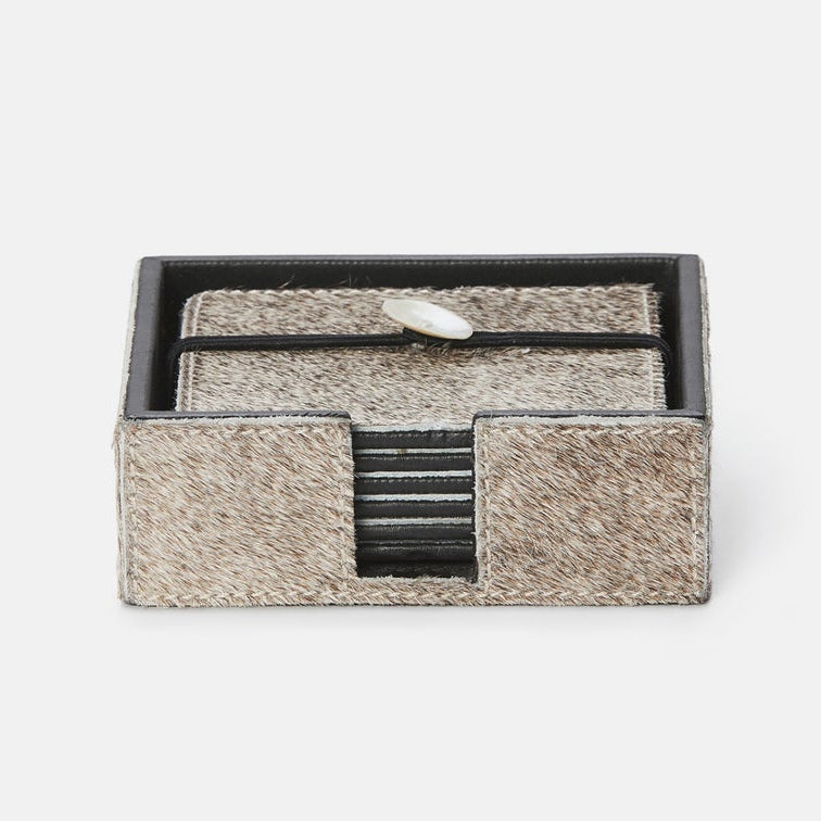 A small rectangular jewelry box with a textured beige and brown exterior, black interior trim, and a ring displayed inside on a plain light gray background.