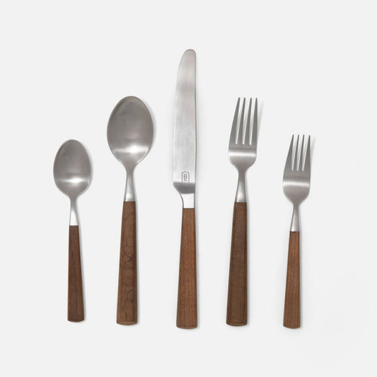 Five-piece flatware set with polished silver metal heads and warm brown wooden handles, arranged vertically on a light gray background.