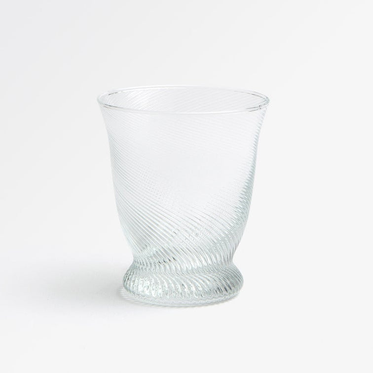 A clear textured glass tumbler with a spiral ribbed pattern, shown on a clean white background.