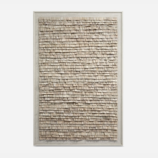 Textured wall art in a silver frame on a white background