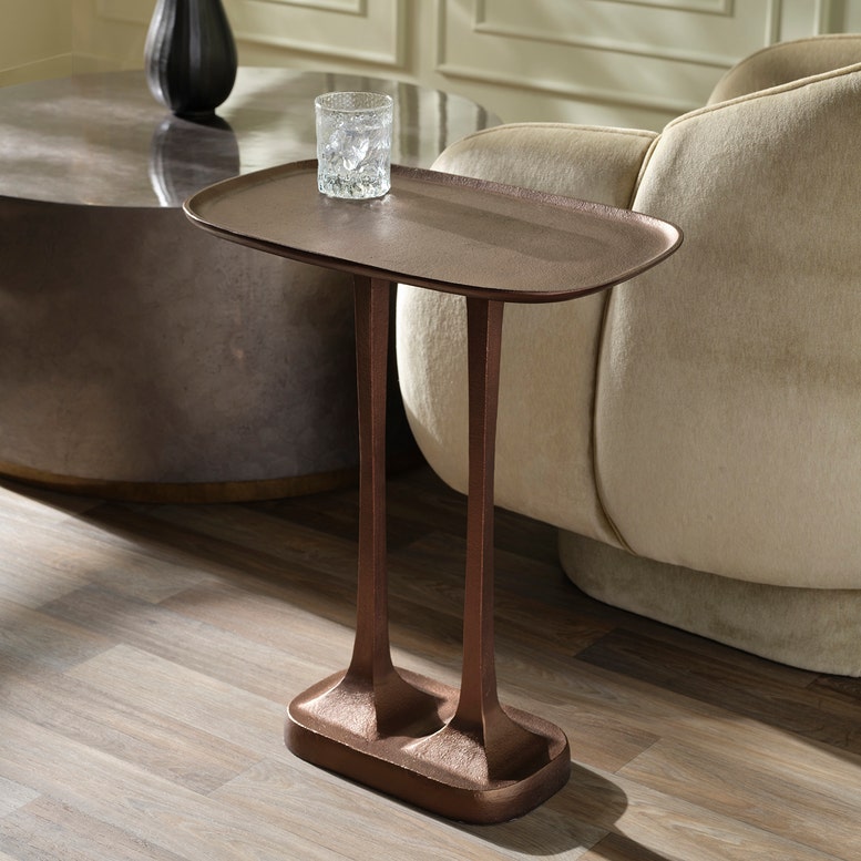 metal side table with a glass of water in a living room setting