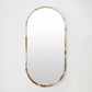 Oval mirror with a decorative frame on a white background