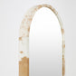 Long, narrow mirror with a brown and white patterned frame on a light gray background