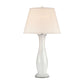 Table lamp with a white base and beige shade on a white background