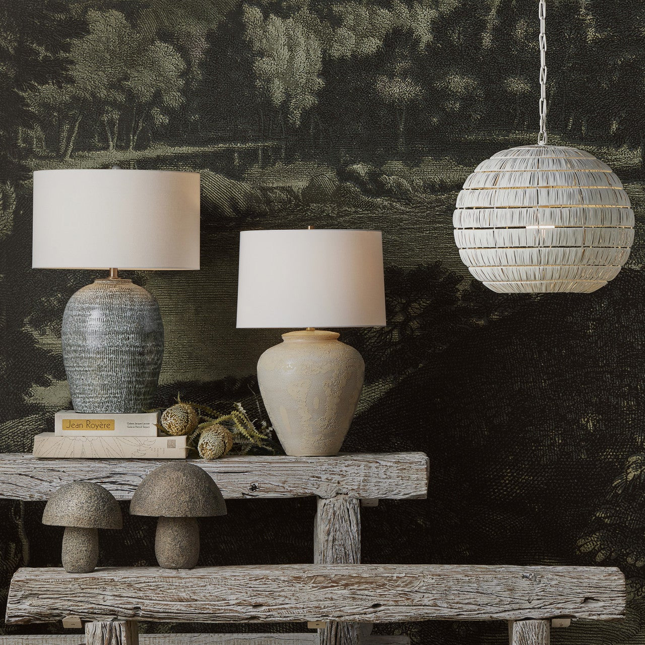 Decorative setting with lamps and a bench against a forest wallpaper.