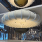 Large white ceiling light fixture in a modern indoor setting