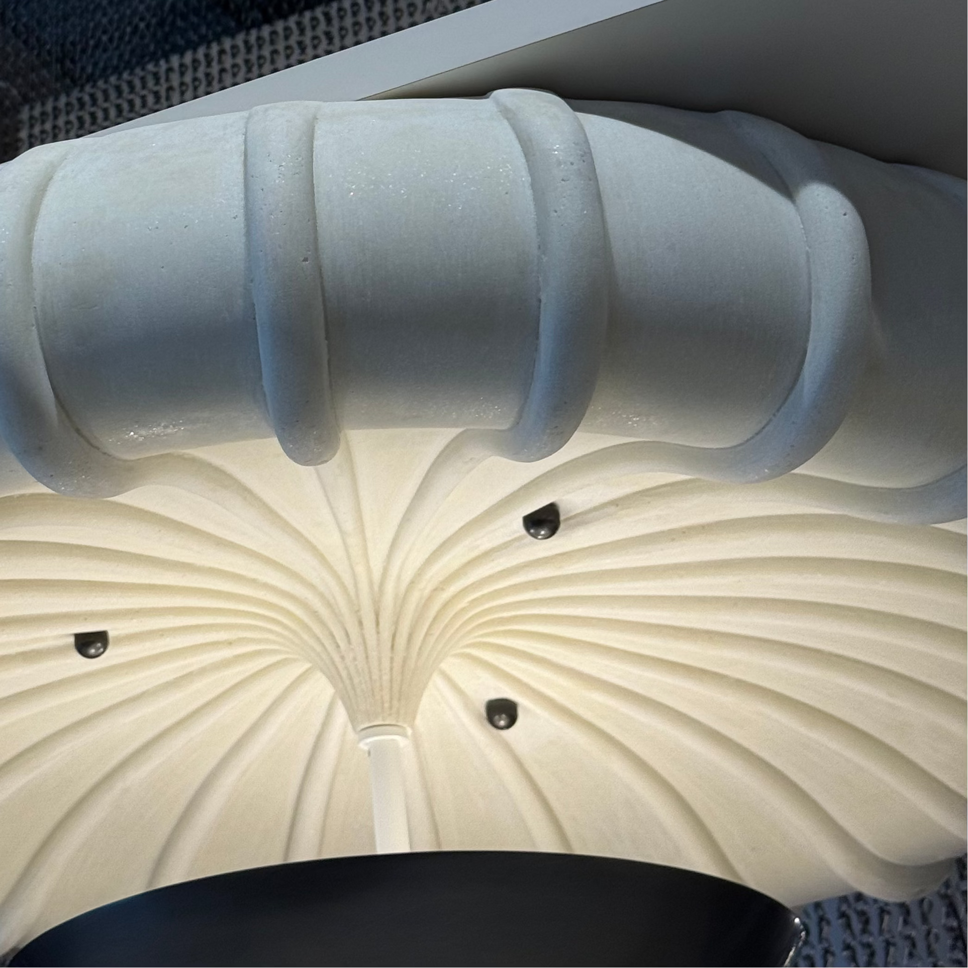 Close-up of decorative ceiling fixtures with a ribbed design.