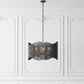 Decorative chandelier hanging against a white paneled wall
