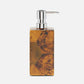 Soap dispenser with wooden finish and silver pump on a white background