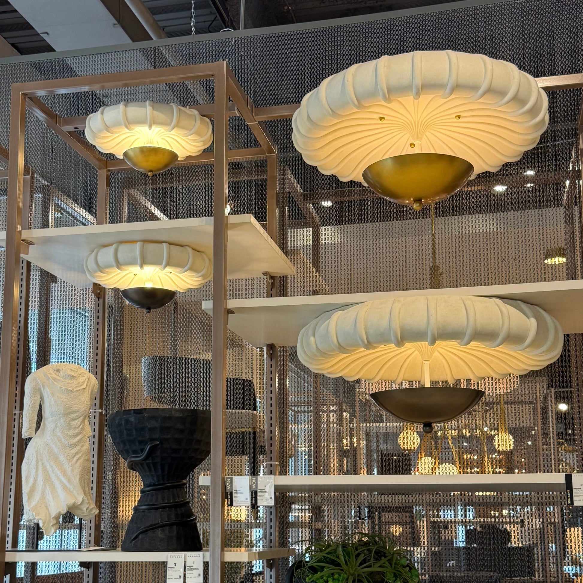Decorative flush mounts hanging in a modern interior setting with chairs and tables.