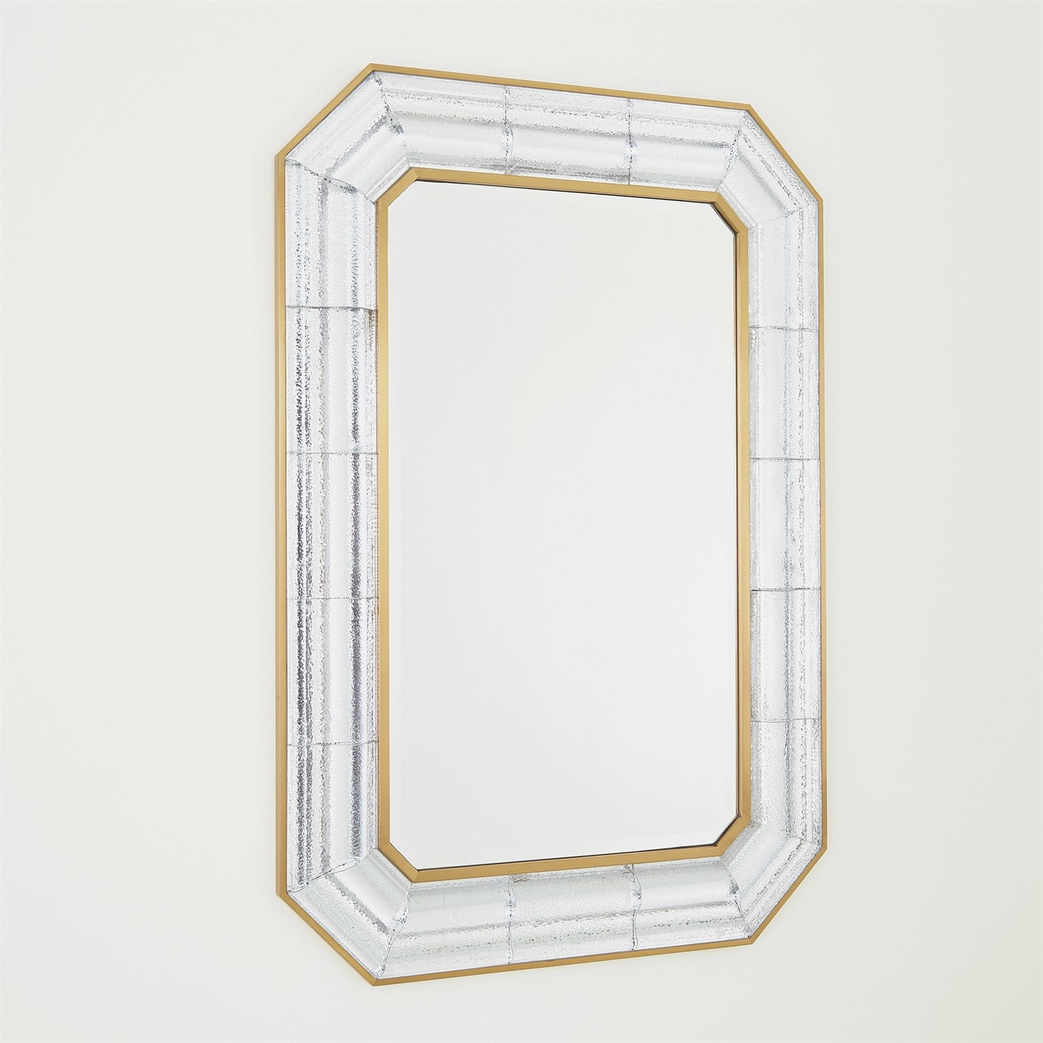 Decorative mirror with a gold and white frame on a light gray background
