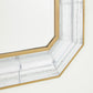 Close-up of a decorative mirror with a marble-like frame on a white background