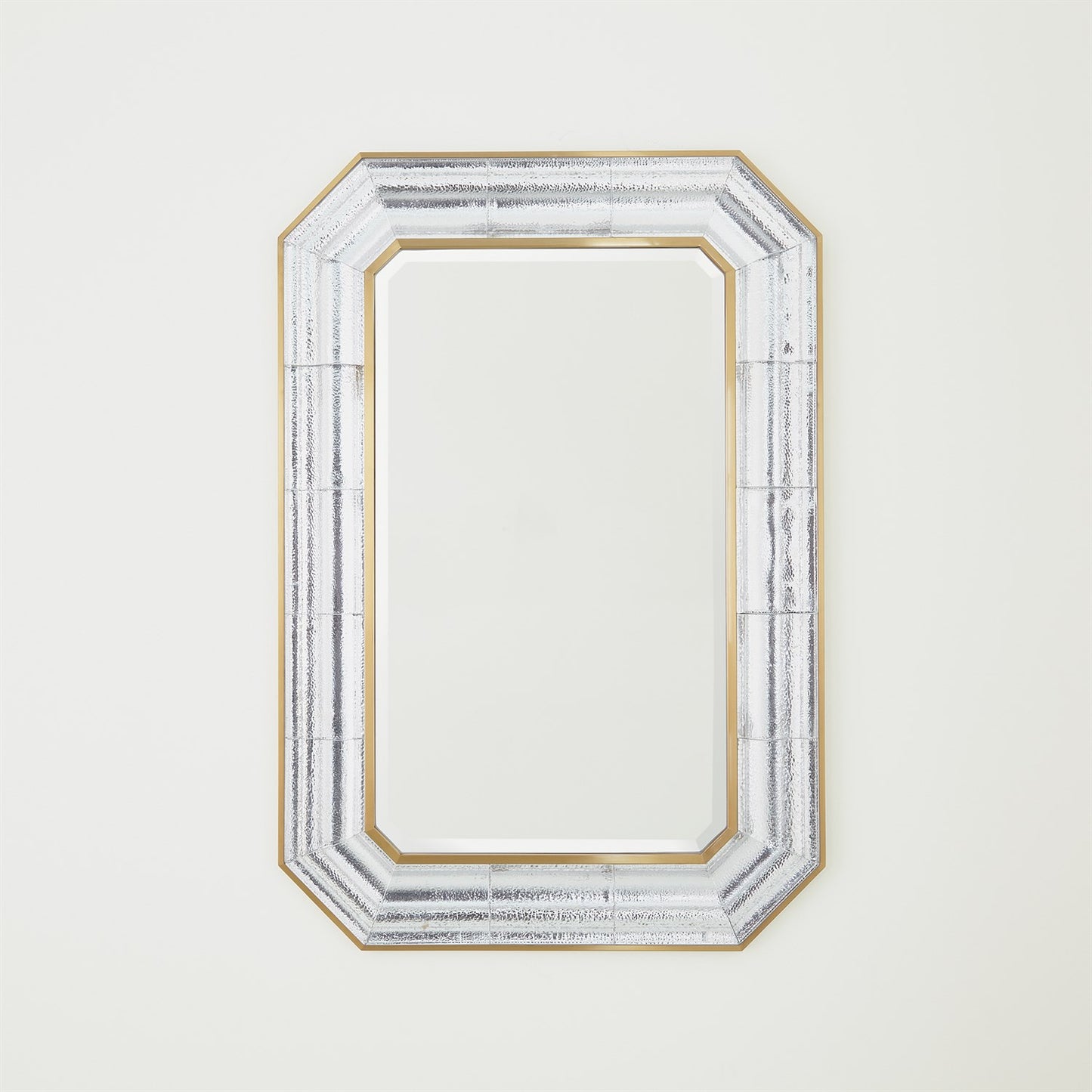 Decorative mirror with a gold and silver frame on a white background