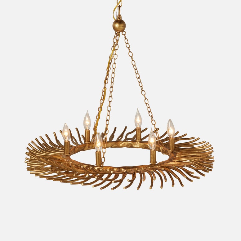 A gold-finished chandelier with a circular ring of sunburst branches holding six candle-style bulbs, suspended by chains against a light gray background.