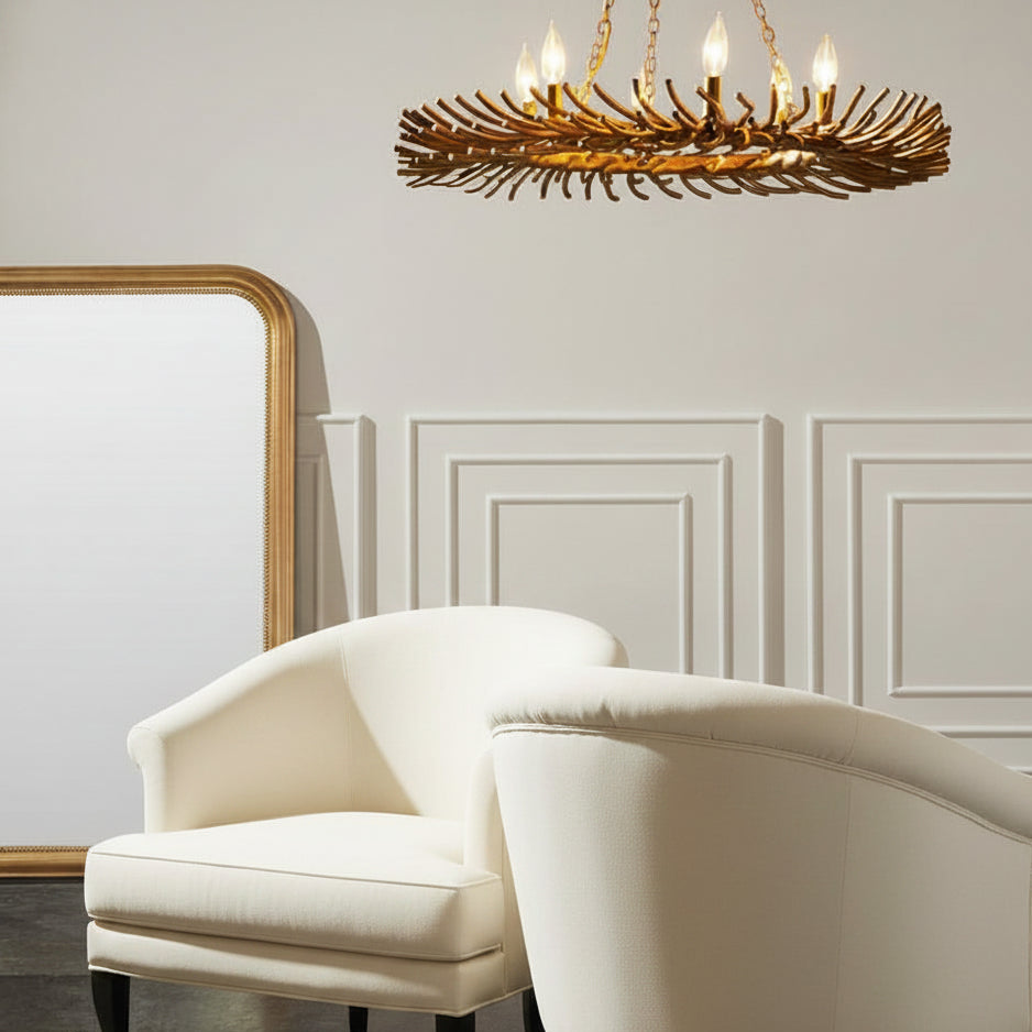 Patterned armchair with ottoman under a gold chandelier in a room with panelled walls.
