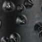 Close-up of a textured black surface with raised circular patterns
