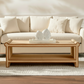 Beige sofa with a wooden coffee table and decorative items in a living room setting.