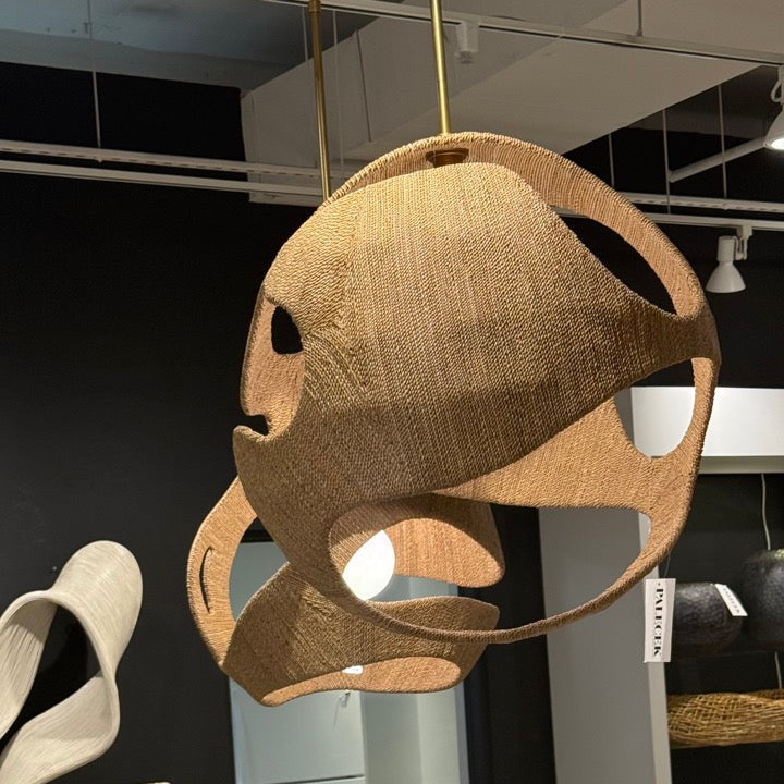 Modern dining chair with woven backrest in a showroom setting