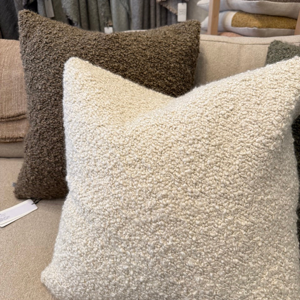Textured pillows on a sofa in a store setting