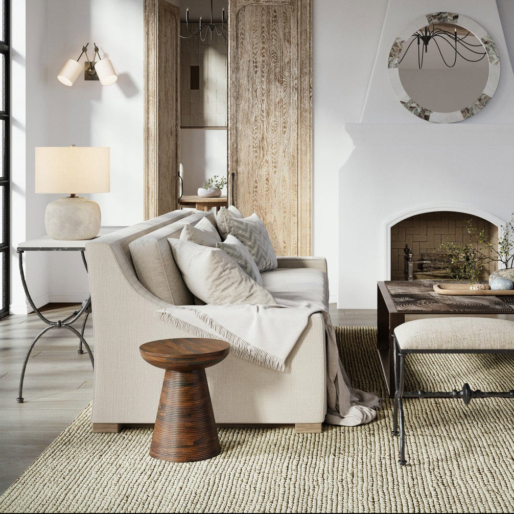 Living room with rustic decor, including a chandelier, fireplace, and wooden beams.