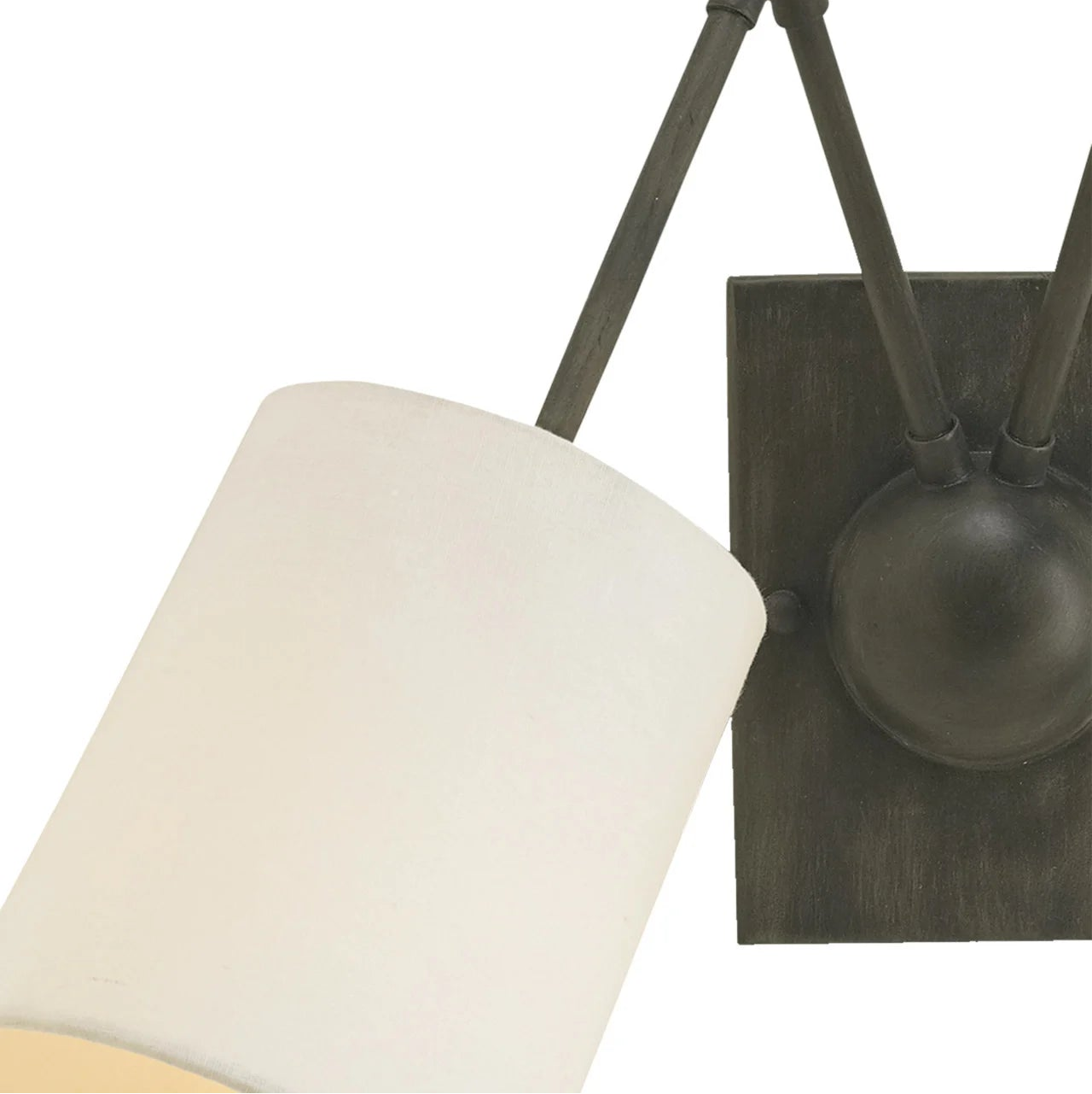 Close-up of a wall-mounted light fixture with a white lampshade on a white background