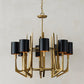 Gold chandelier with black lampshades on a neutral background