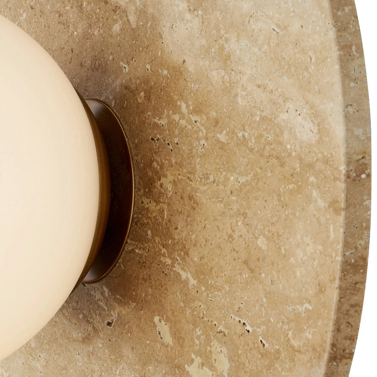 Close-up of a textured stone surface with a beige bowl.